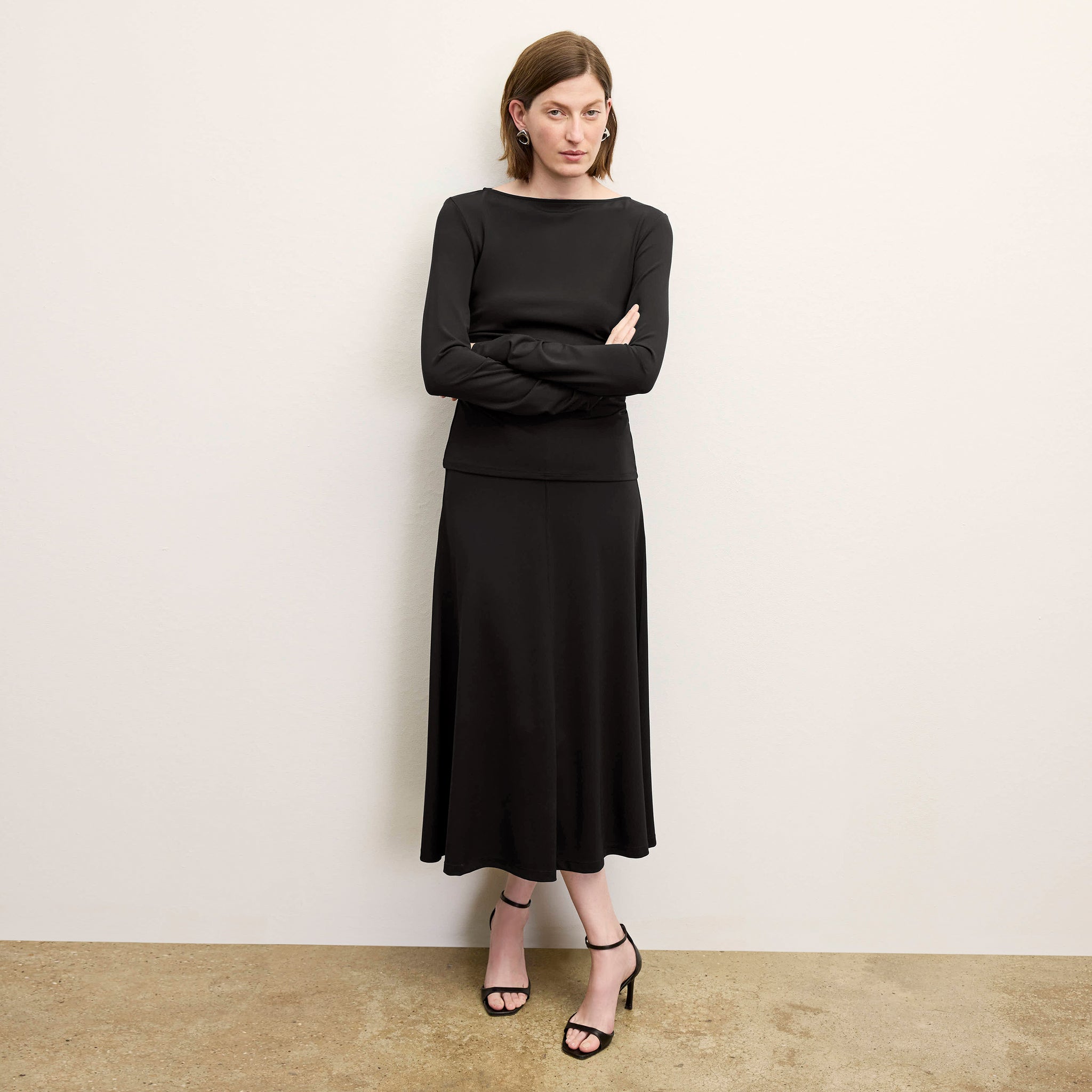 front image of a woman wearing the misty skirt in black 
