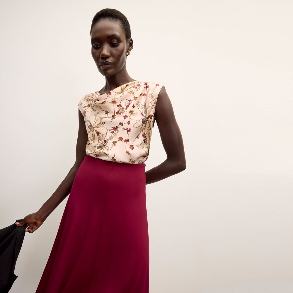 front image of a woman wearing the misty skirt in grenache