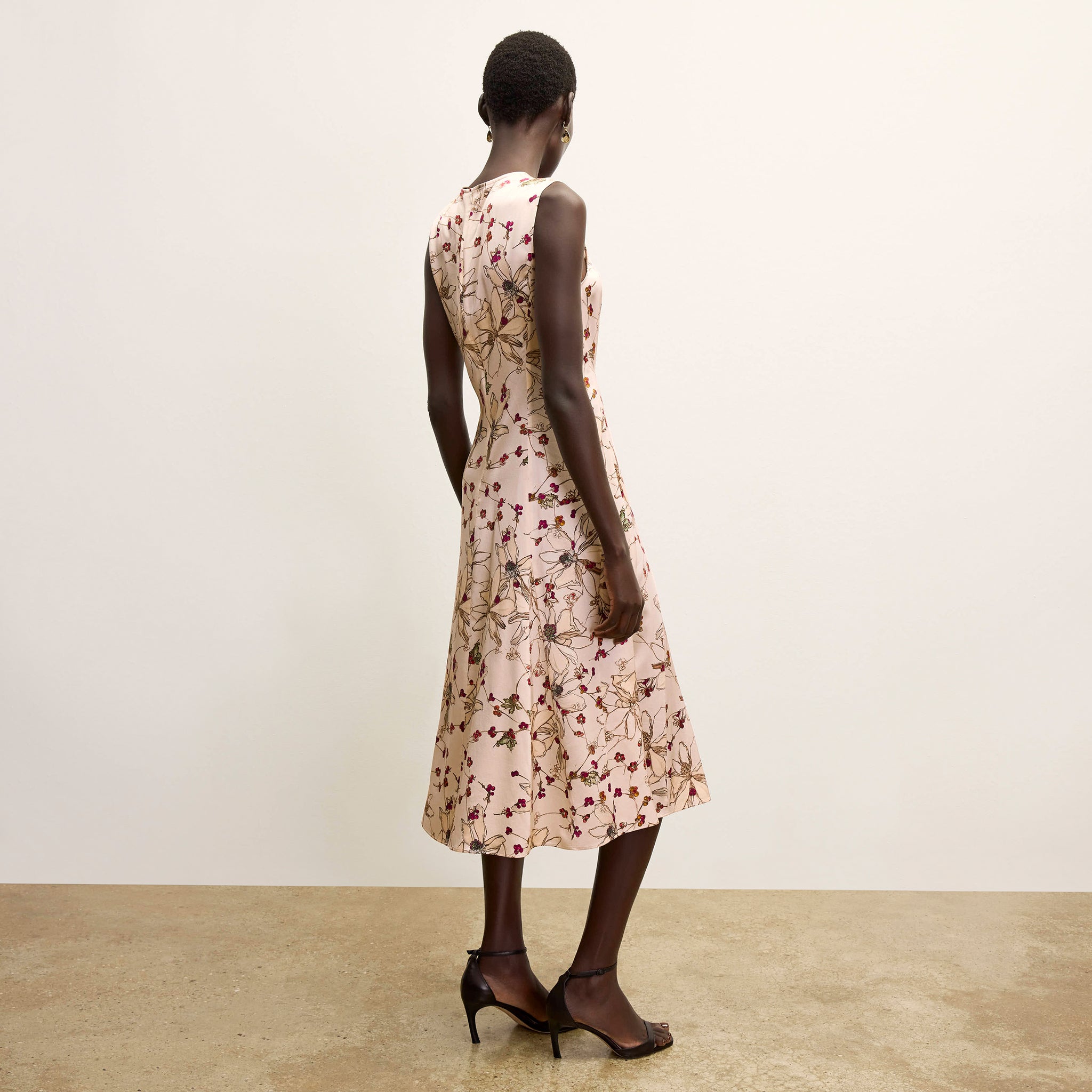 back image of a woman wearing the nyla dress in botanical print