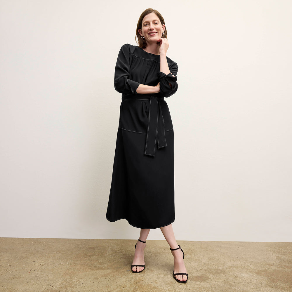 front image of a woman wearing the edie dress in black