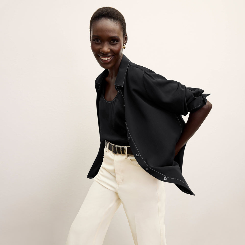 front image of a woman wearing the mira top in black