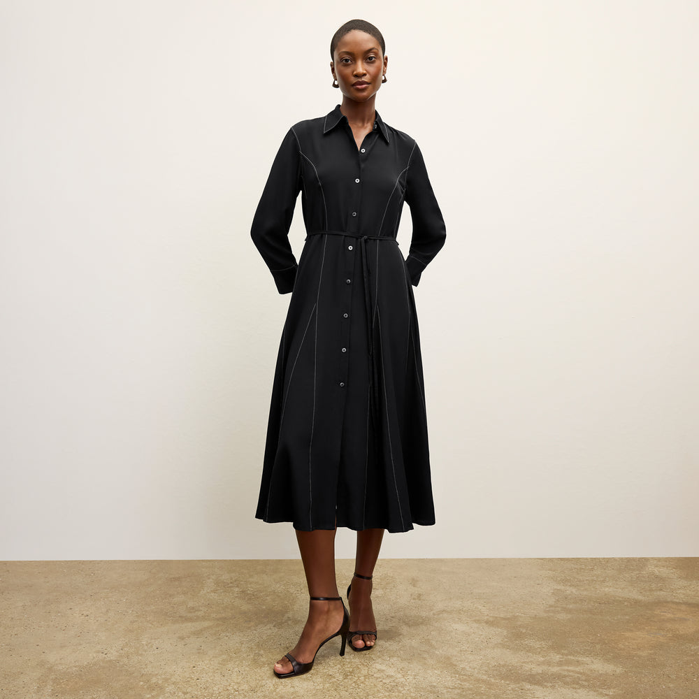 front image of a woman wearing the pepper dress in black