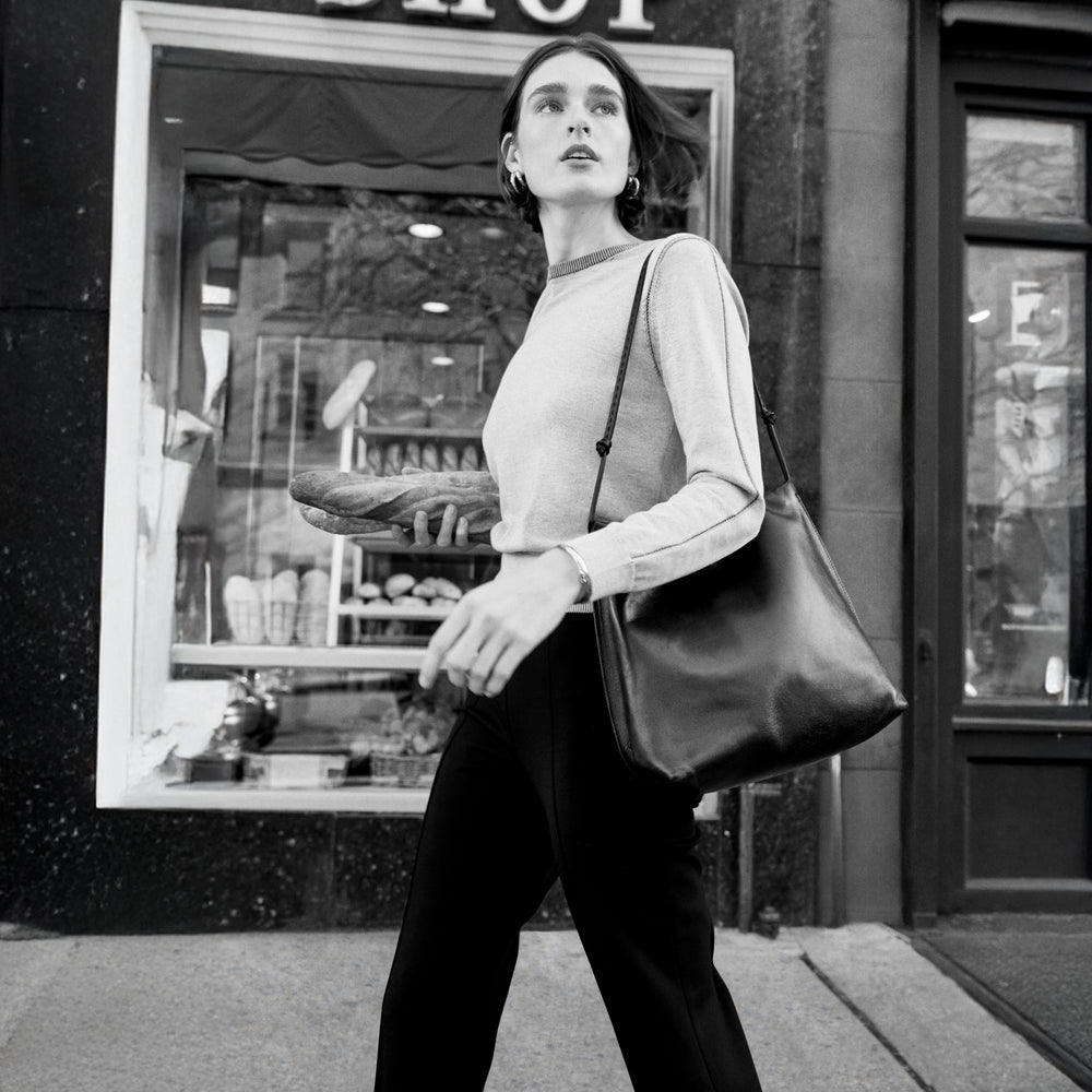 Front image of a woman wearing the larissa sweat in light gray/ivory