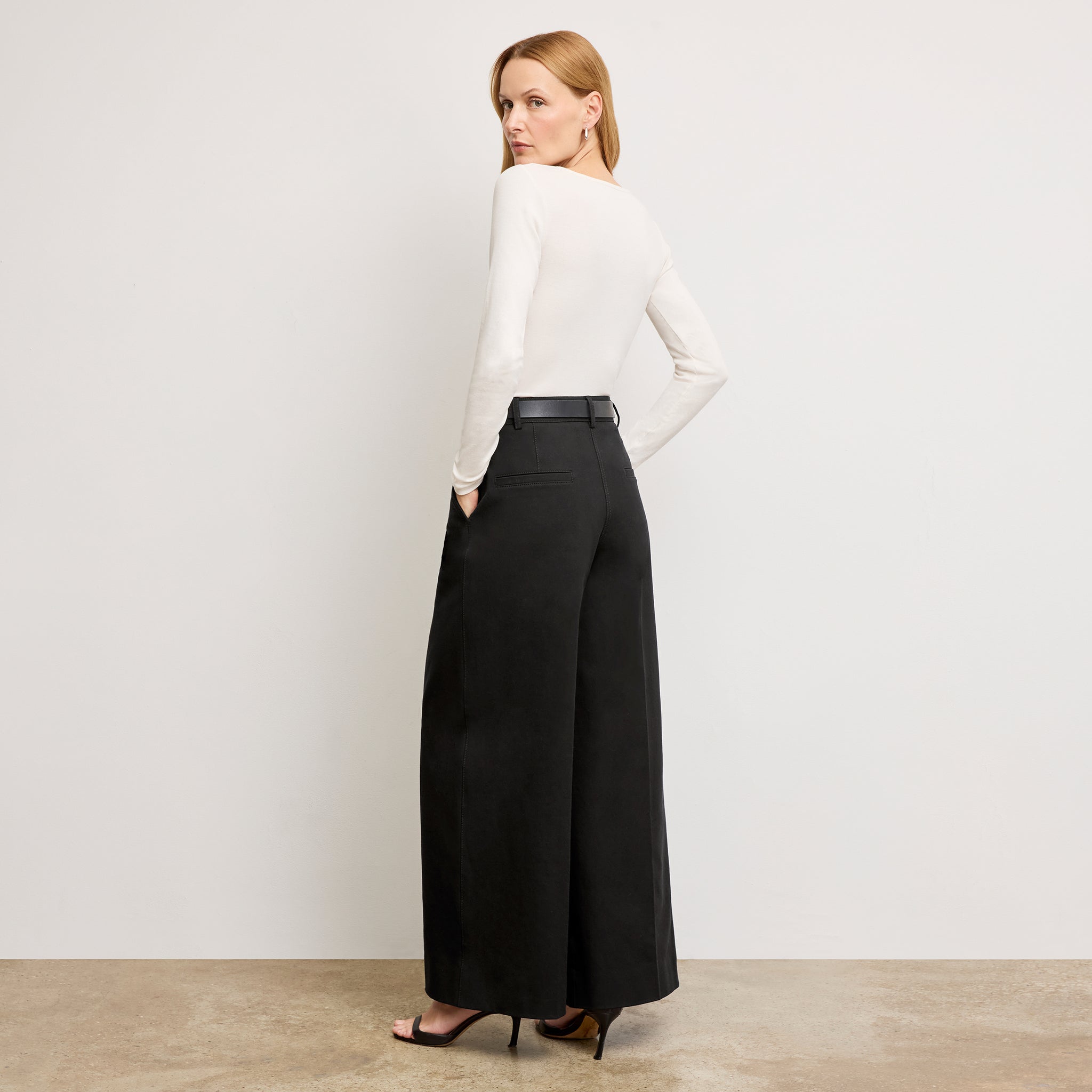 Back image of a woman wearing the Harrison Pant in Black