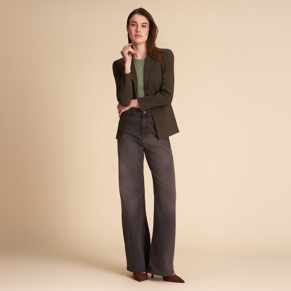 Front image of a woman wearing the Moreland jacket in olive