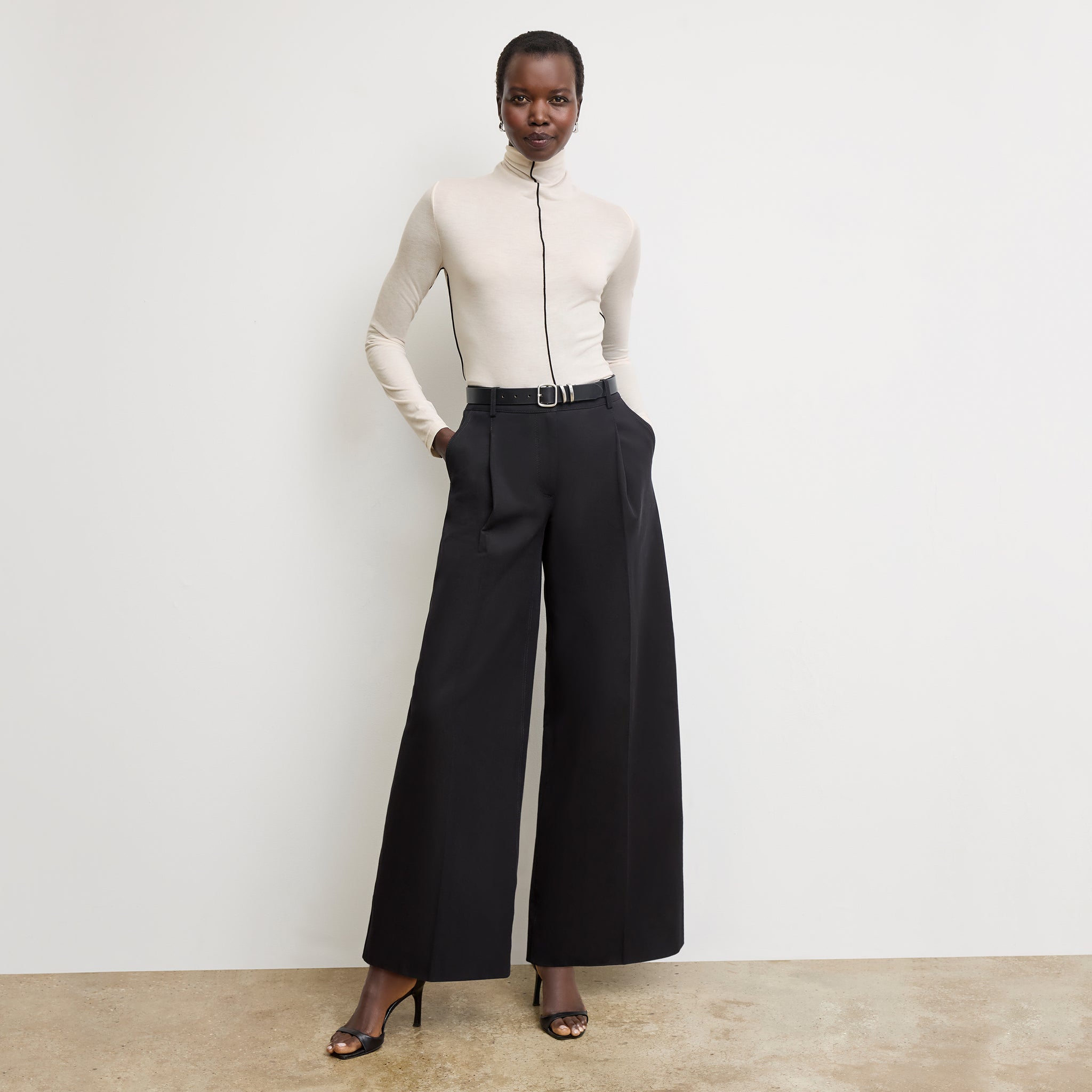 Front image of a woman wearing the Harrison Pant in Black