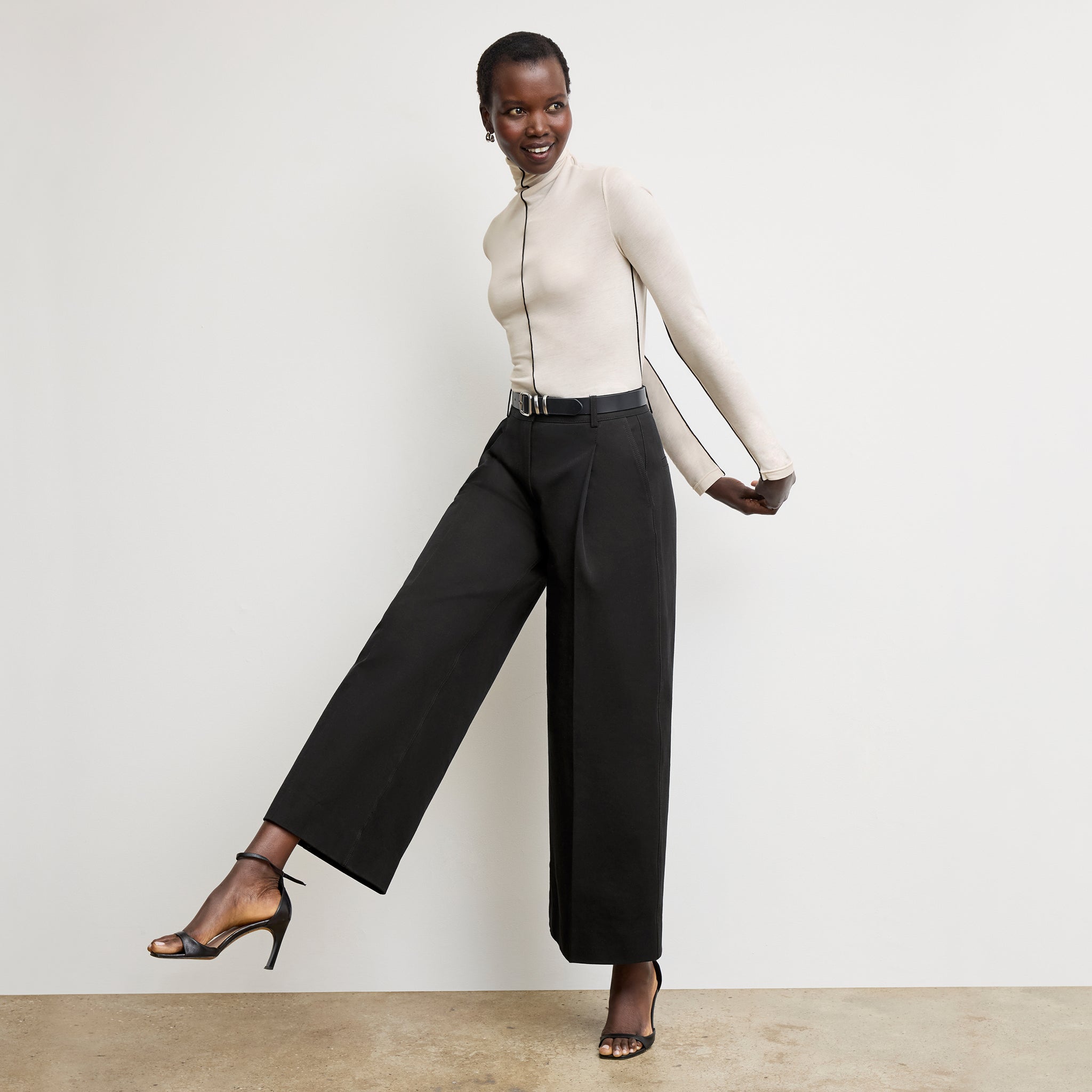 Front image of a woman wearing the Harrison Pant in Black