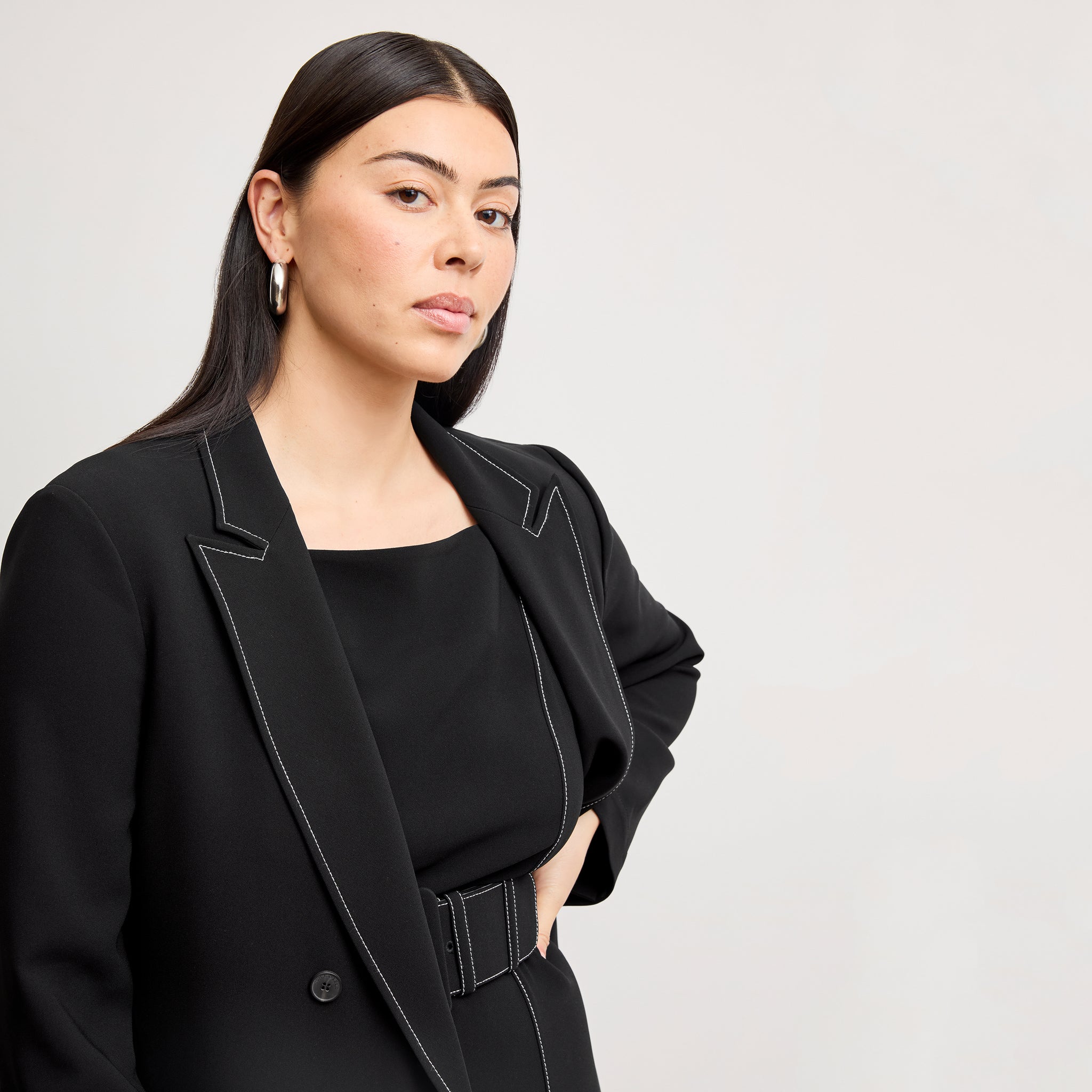 front image of a woman wearing the o'hara jacket in black with topstitch 