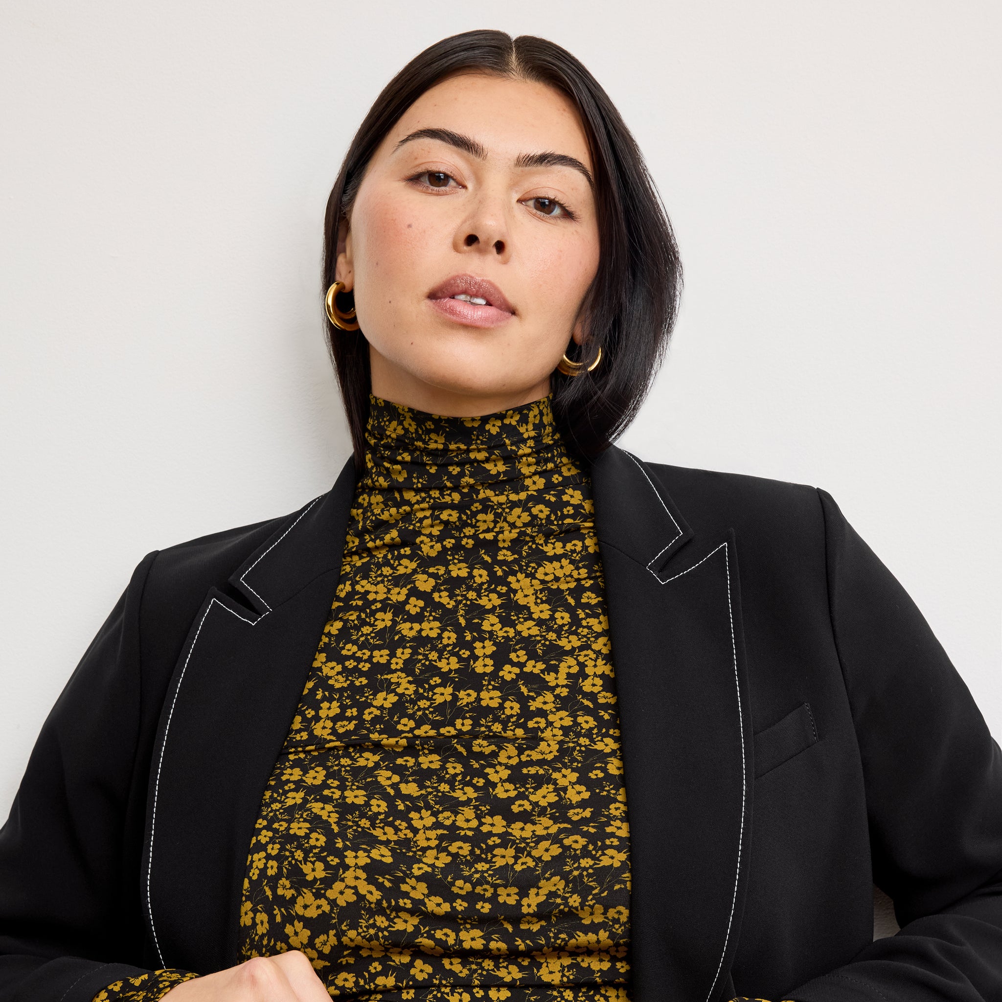 front image of a woman wearing the o'hara jacket in black with topstitch 