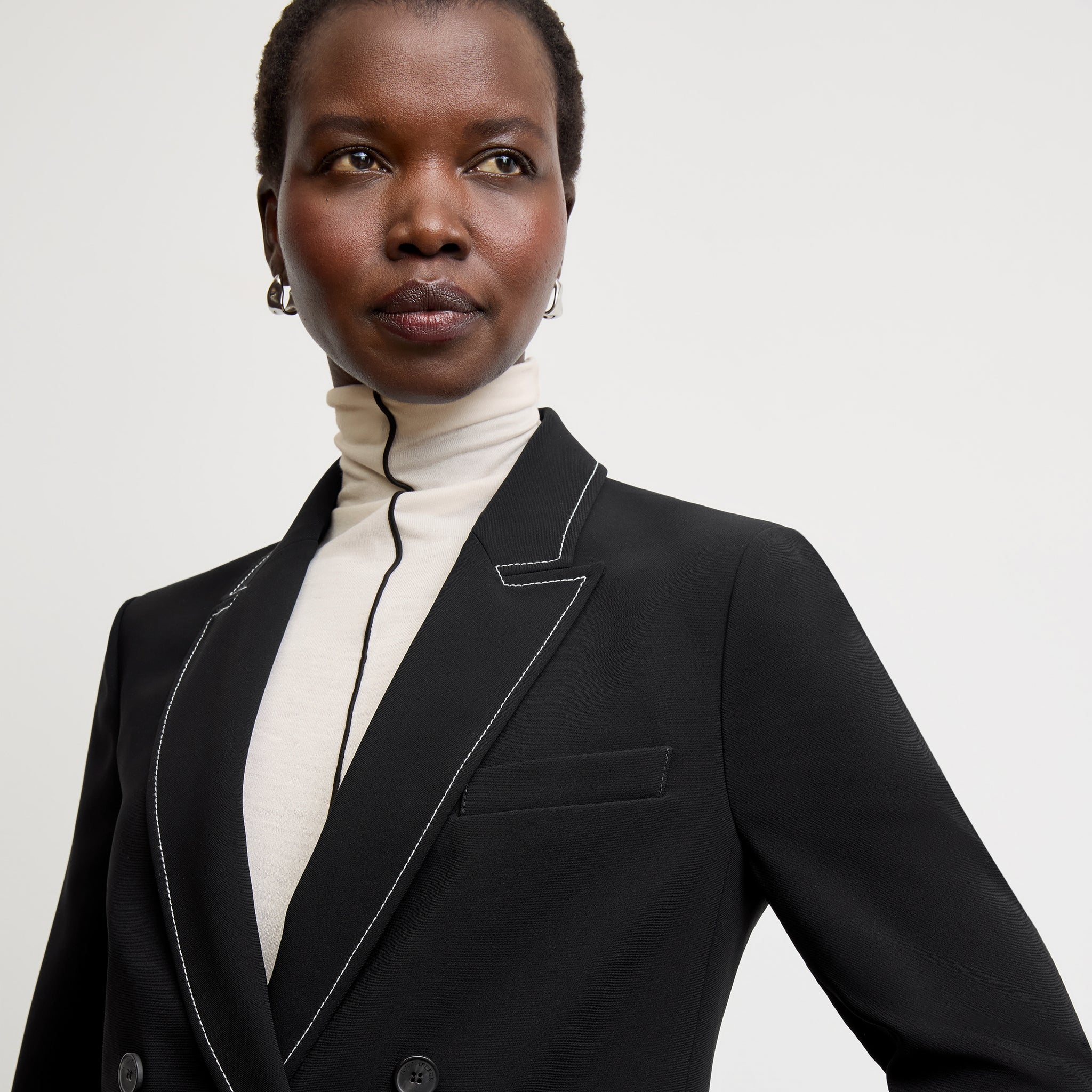 front image of a woman wearing the o'hara jacket in black with topstitch 