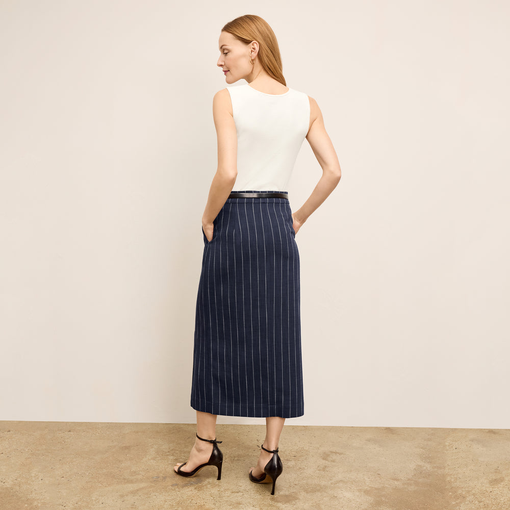 Back image of a woman standing wearing the paige top in fine ribbed cotton in ivory