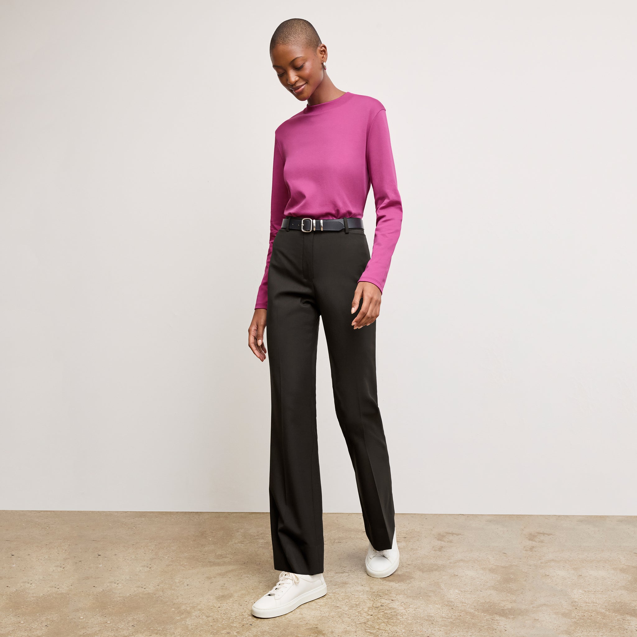 Front image of a woman sitting wearing the Horton pant in black 