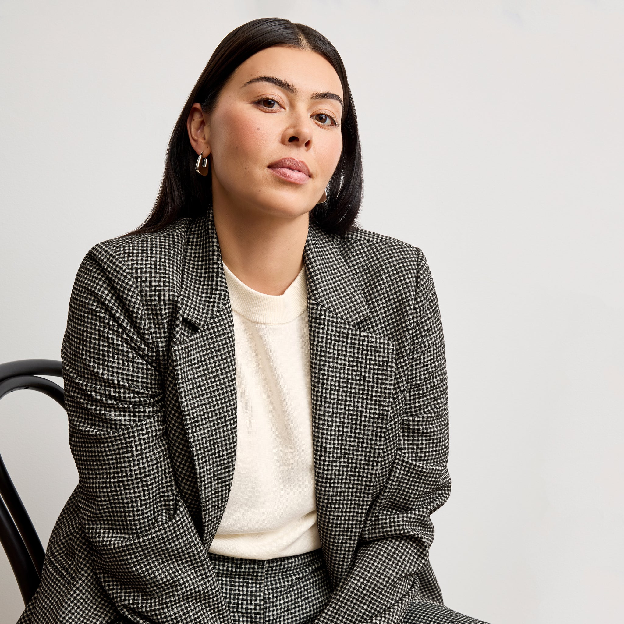 front image of a woman wearing the rossi blazer in classic check