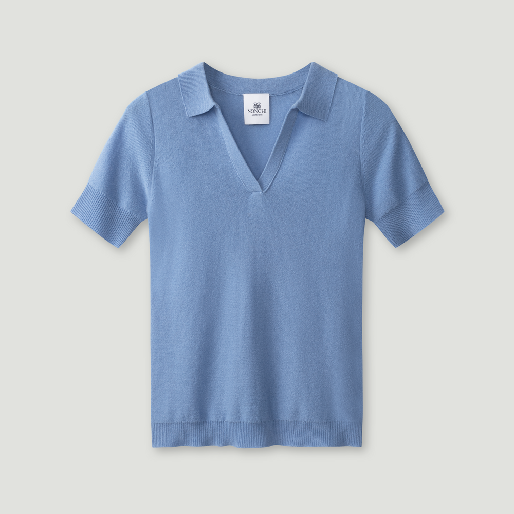 Blue polo shirt on a light gray background.