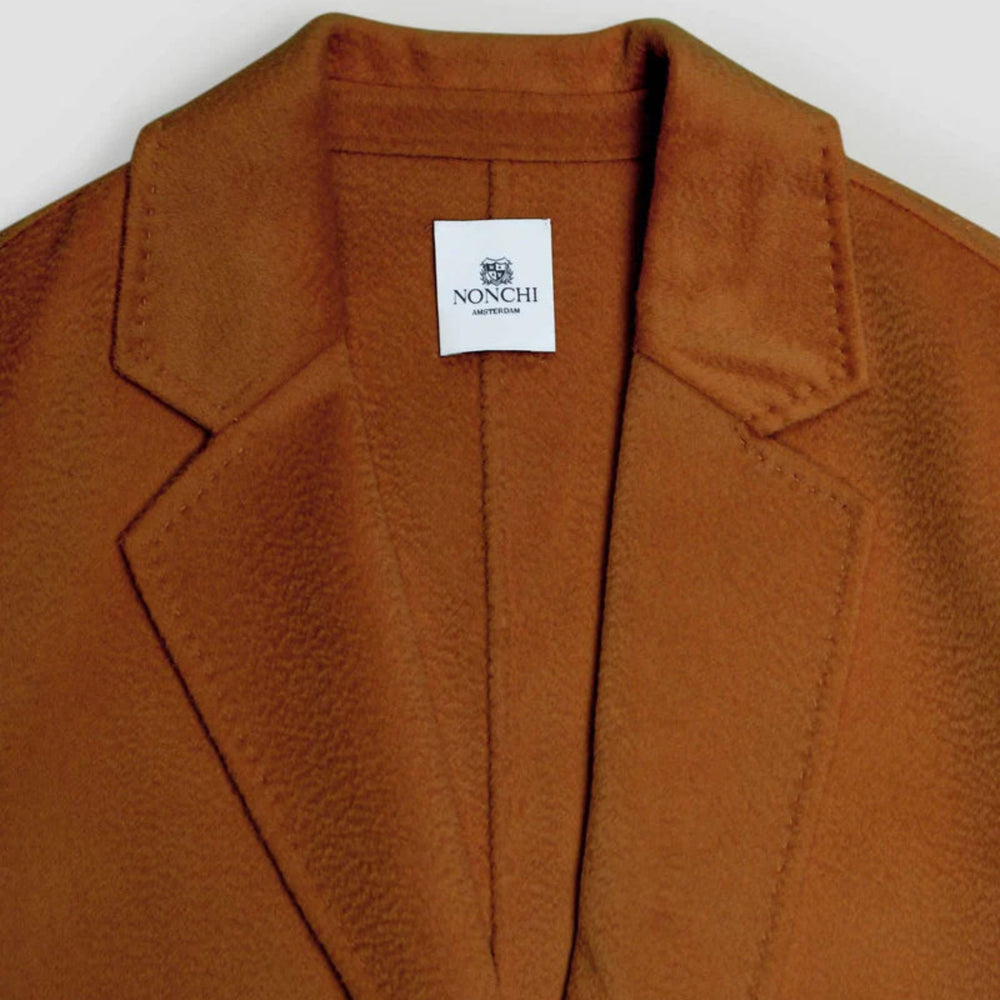 Brown coat with a Nonchi label on a white background