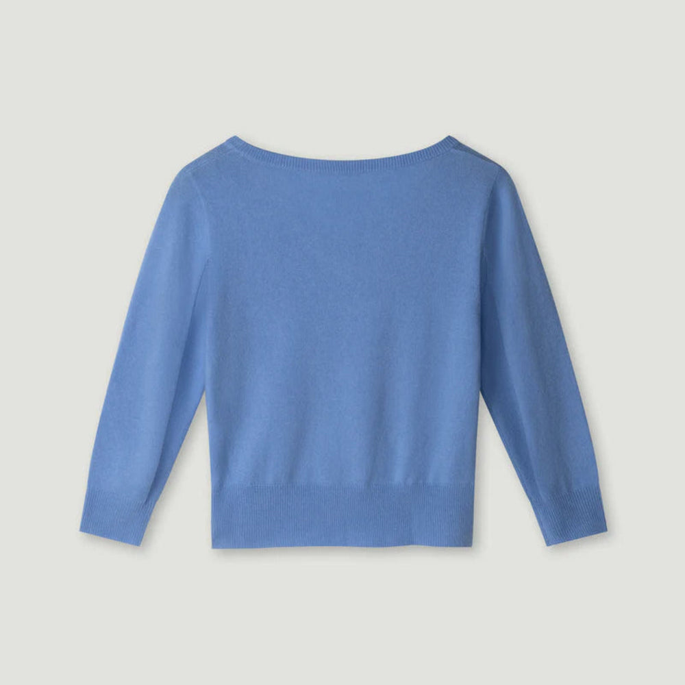 Blue long-sleeve top on a light gray background.
