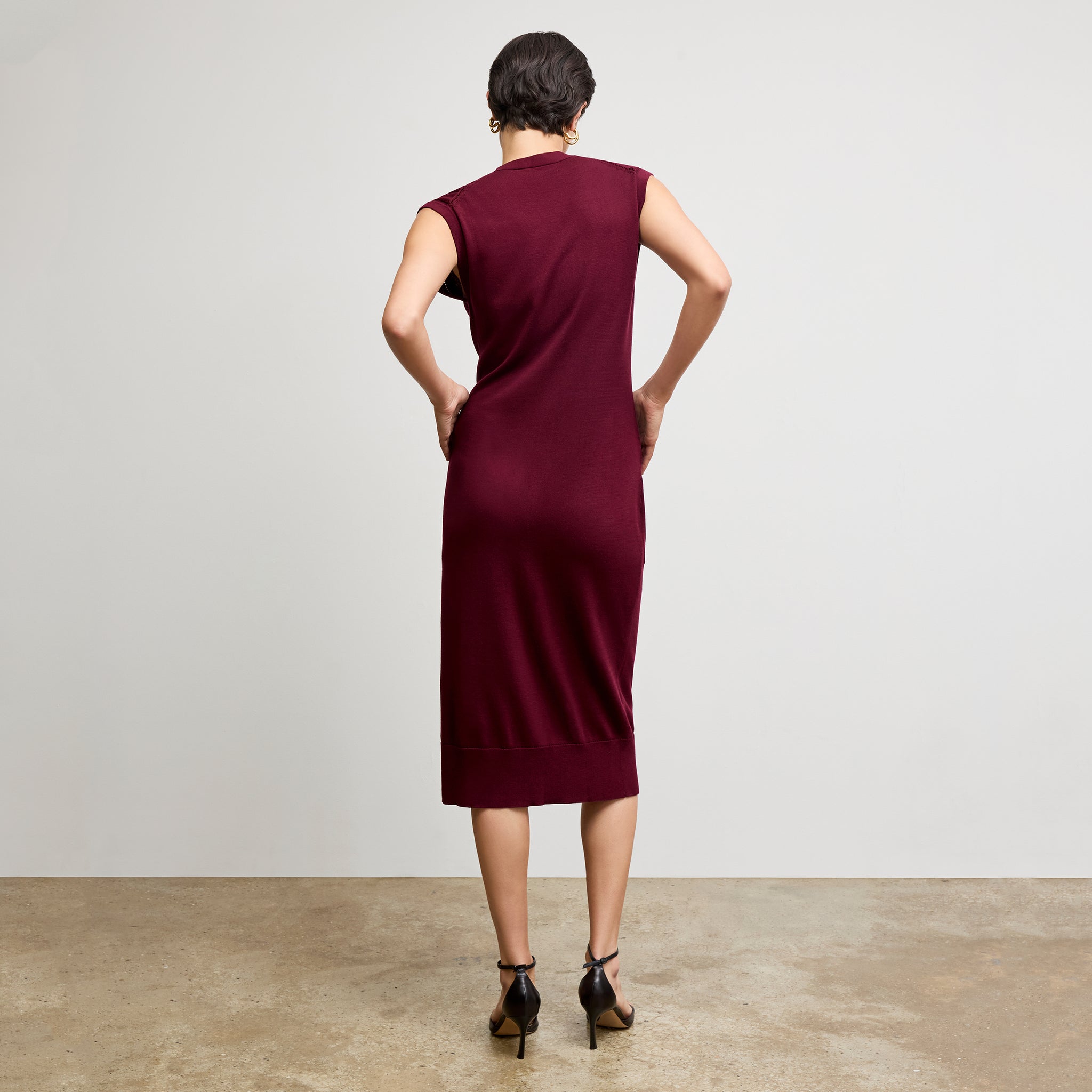 back image of a woman wearing the toula dress in syrah