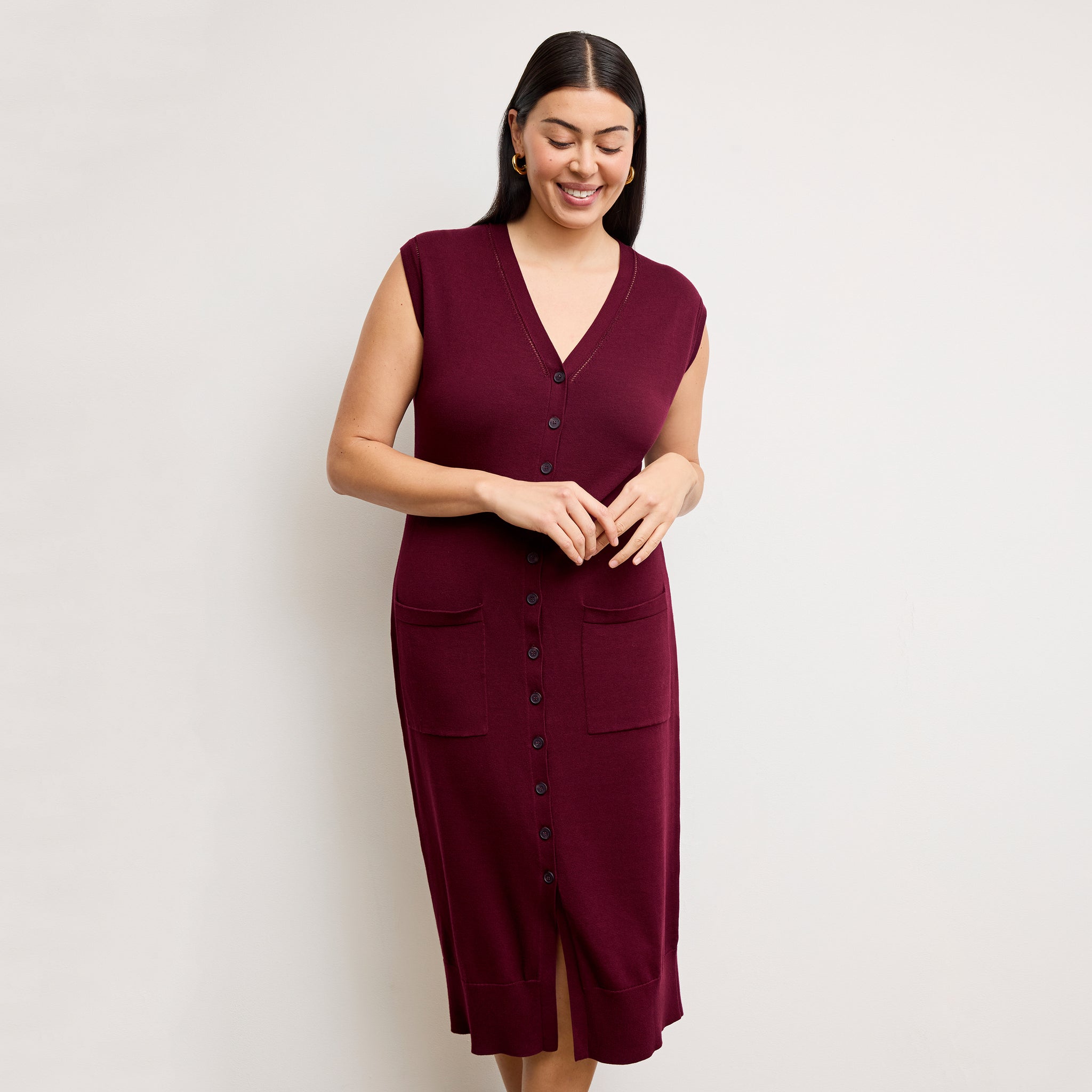 front image of a woman wearing the toula dress in syrah