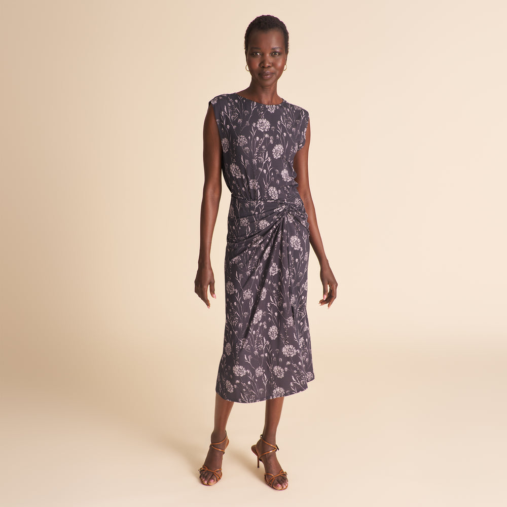 Woman wearing a floral dress on a beige background