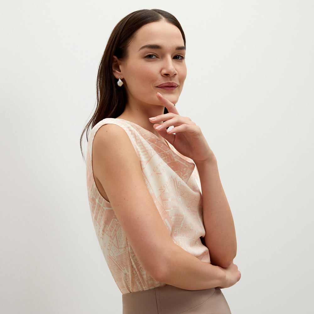 Side image of a woman standing wearing the Rowling top in ivory / cameo