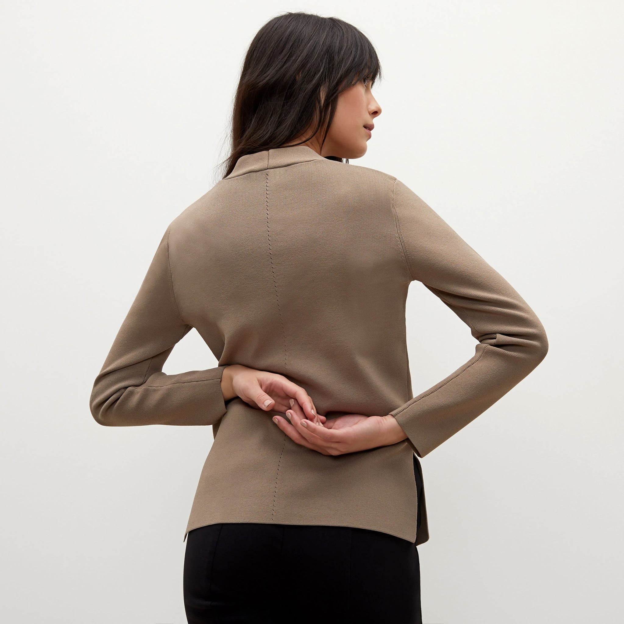 Back image of a woman standing wearing the Woolf jardigan in Taupe