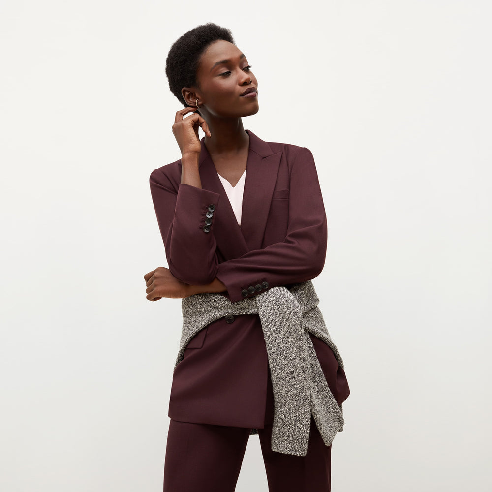 Front image of a woman standing wearing the O'Hara Blazer-Sharkskin in garnet