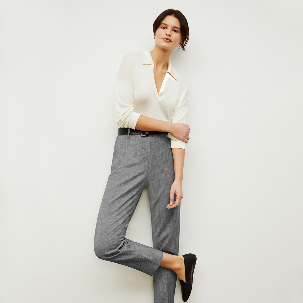 Front image of a woman standing wearing the leo top in cream