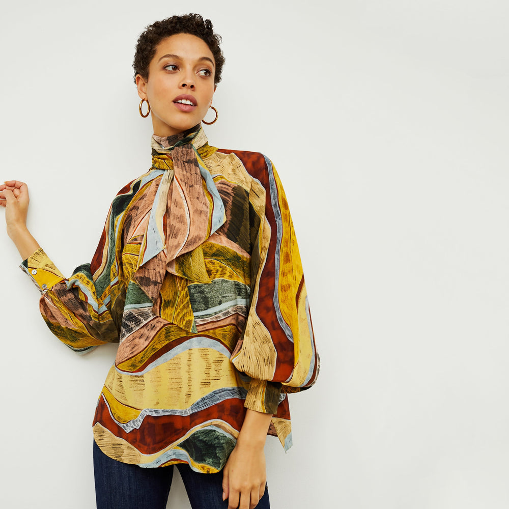 Front image of a woman standing wearing the Fiona Top—Silk Desert in Multicolor