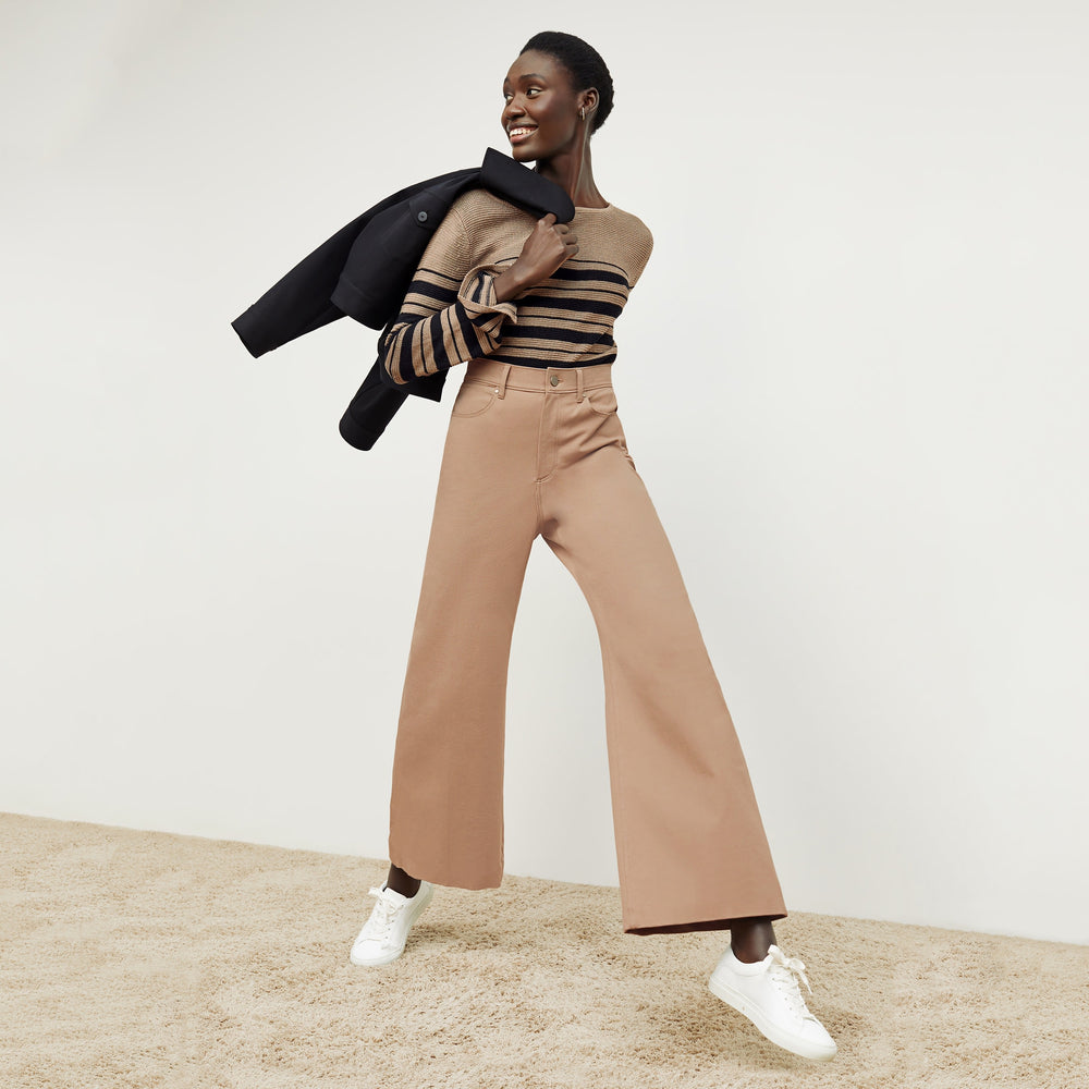 Front image of a woman standing wearing the Samara Sweater—Knit Linen in Oak / Black