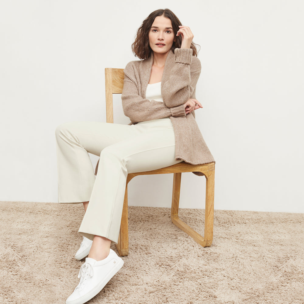 Front image of a woman standing wearing the Frederick Cardigan in Dark Taupe