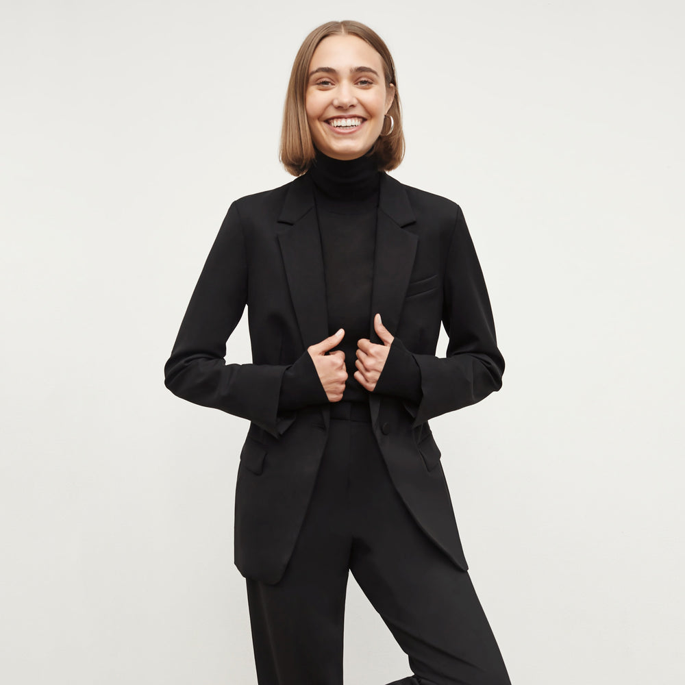 Front image of a woman wearing the elizabeth top in black