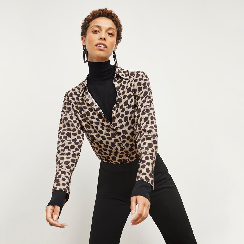 Front image of a woman wearing the elizabeth top in black