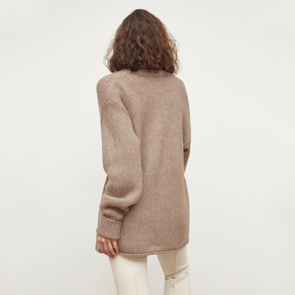 Back image of a woman standing wearing the Frederick Cardigan in Dark Taupe