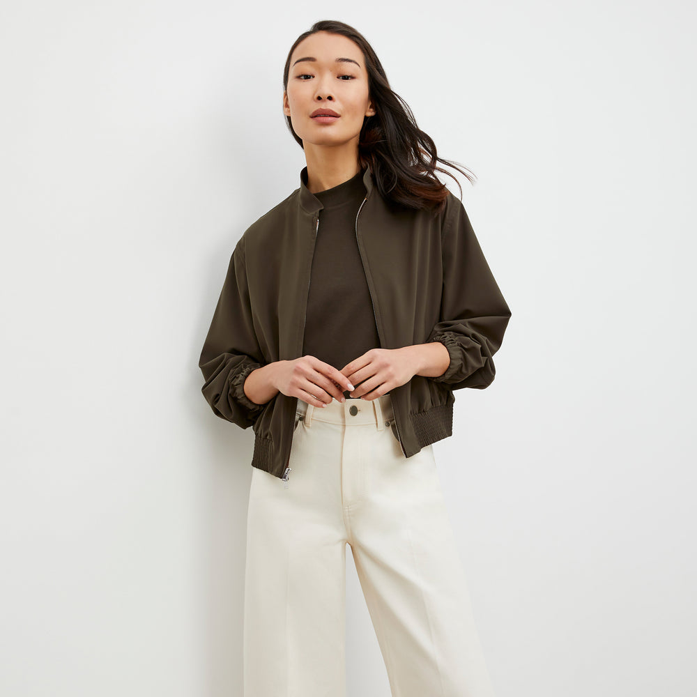Front image of a woman wearing the Langley Bomber - OrigamiTech in Olive