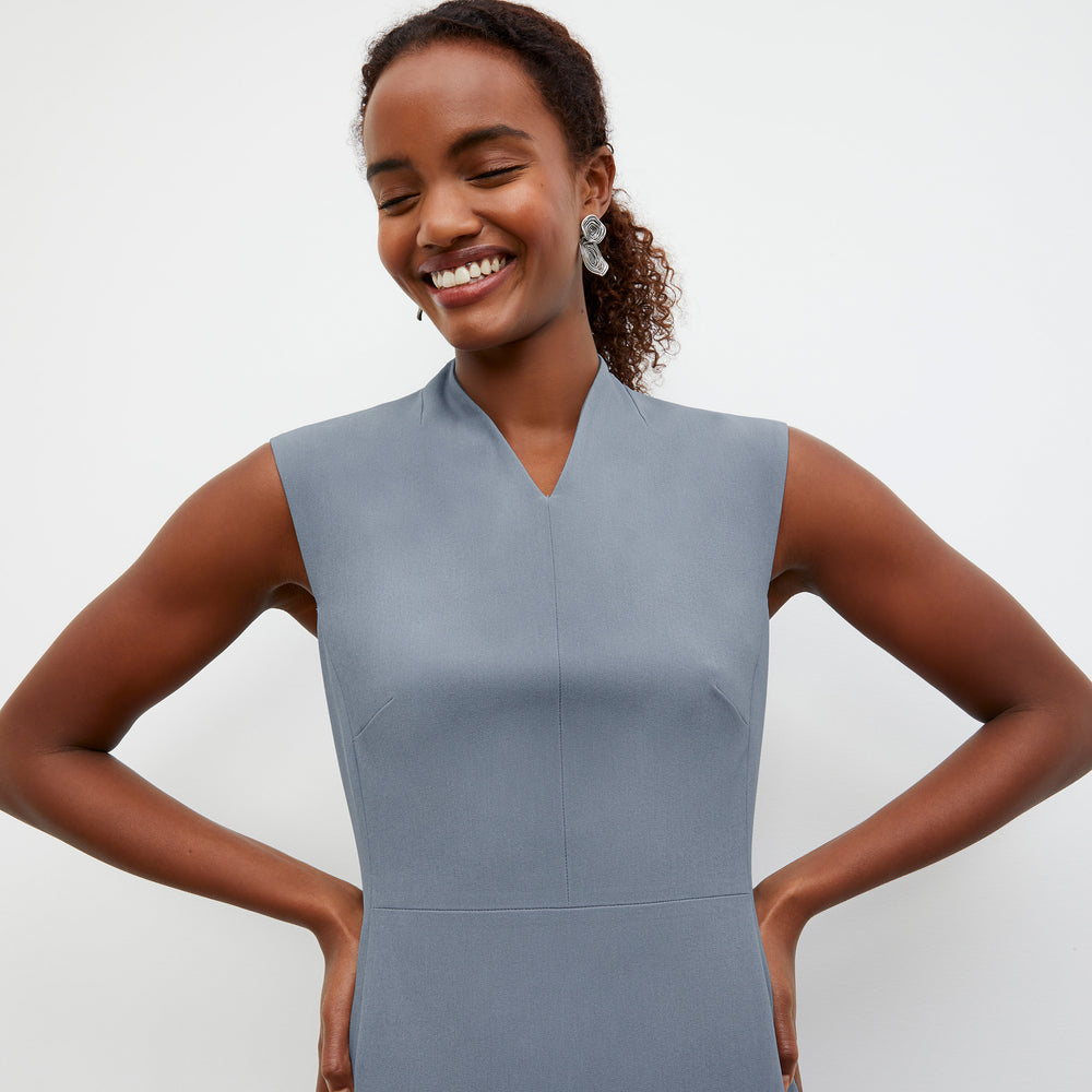 Front image of a woman standing wearing the Aditi Dress in Denim Blue