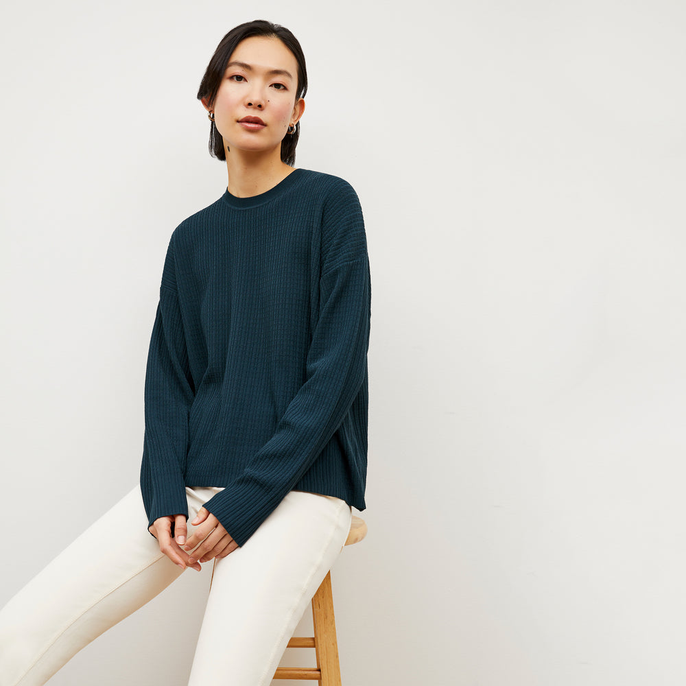 Front image of a woman wearing the Tyler Sweatshirt - Geo Micro Knit in Deep Sea