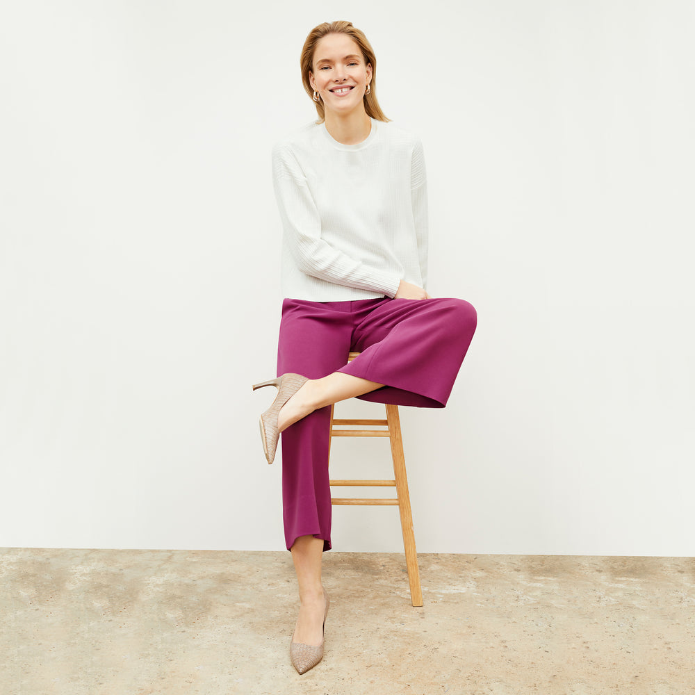 Front image of a woman standing wearing the tyler sweatshirt in ivory