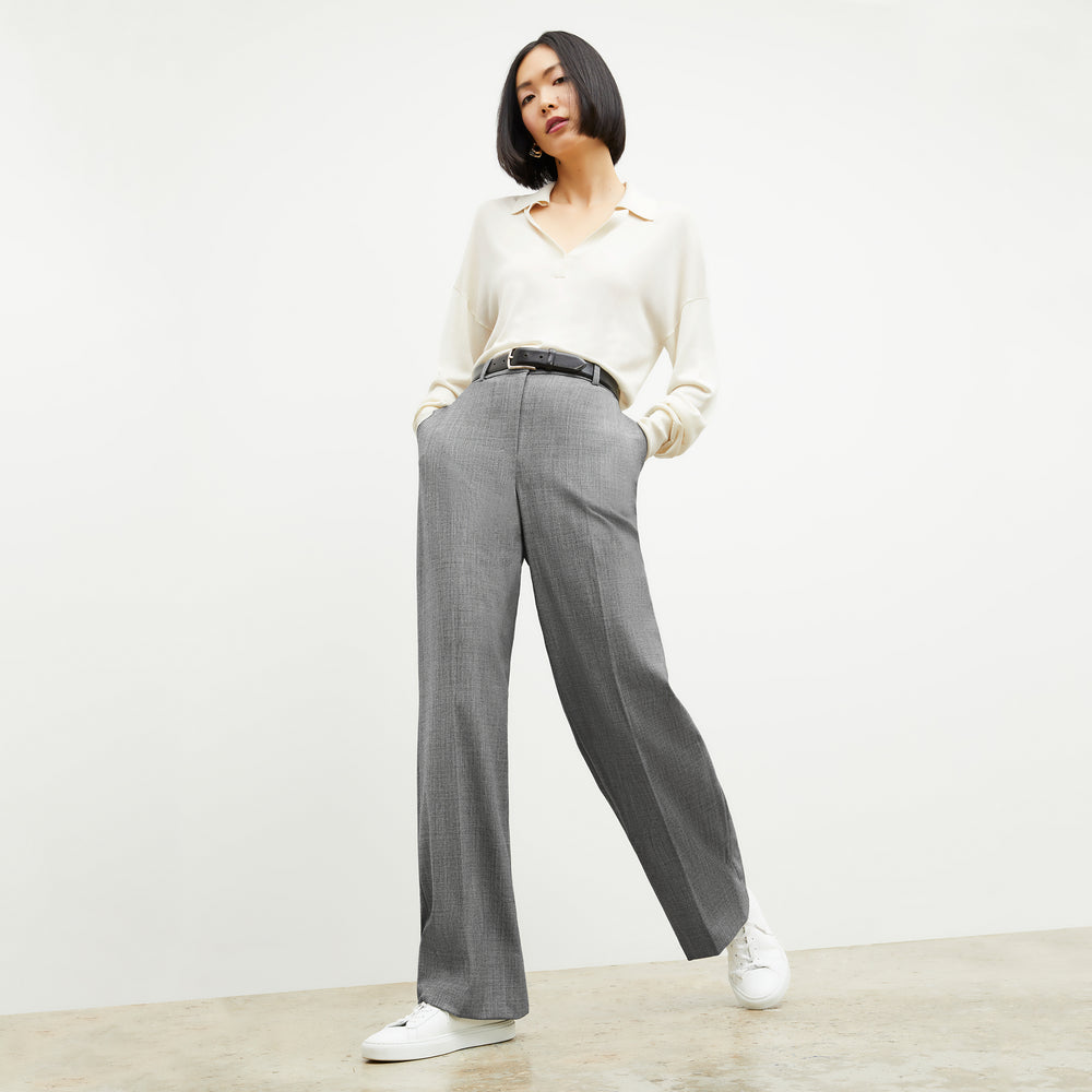 Front image of a woman standing wearing the leo top in cream