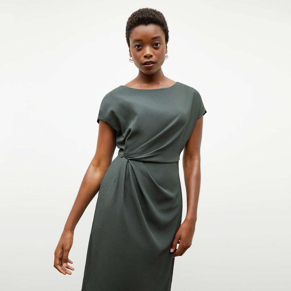 Front image of a woman wearing the jillian dress in aloe