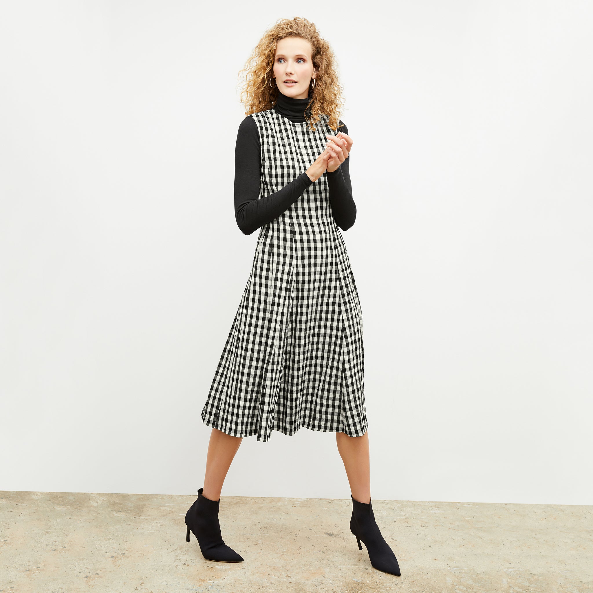 Front image of a woman wearing the nyla dress in black and white