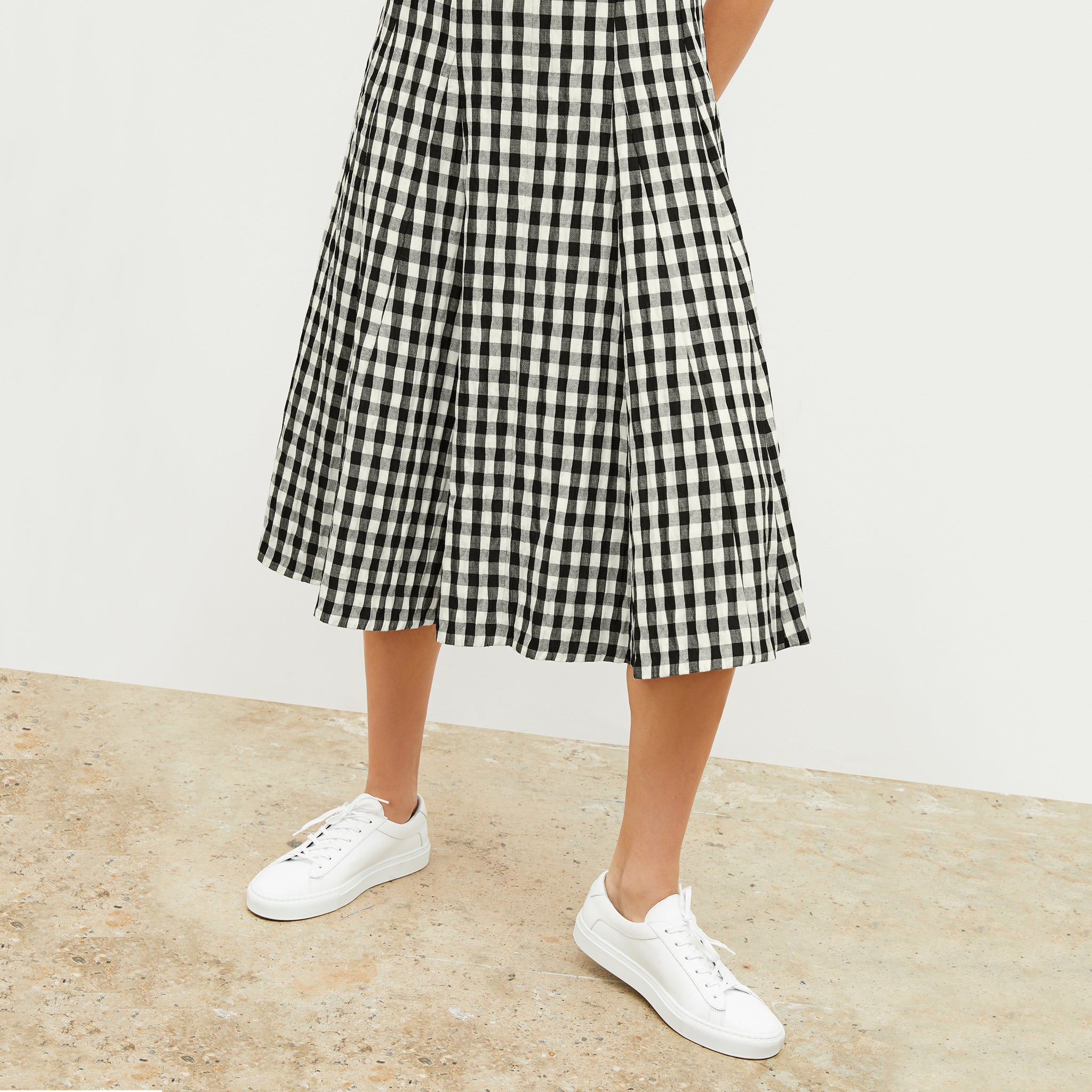 Front image of a woman wearing the nyla dress in black and white