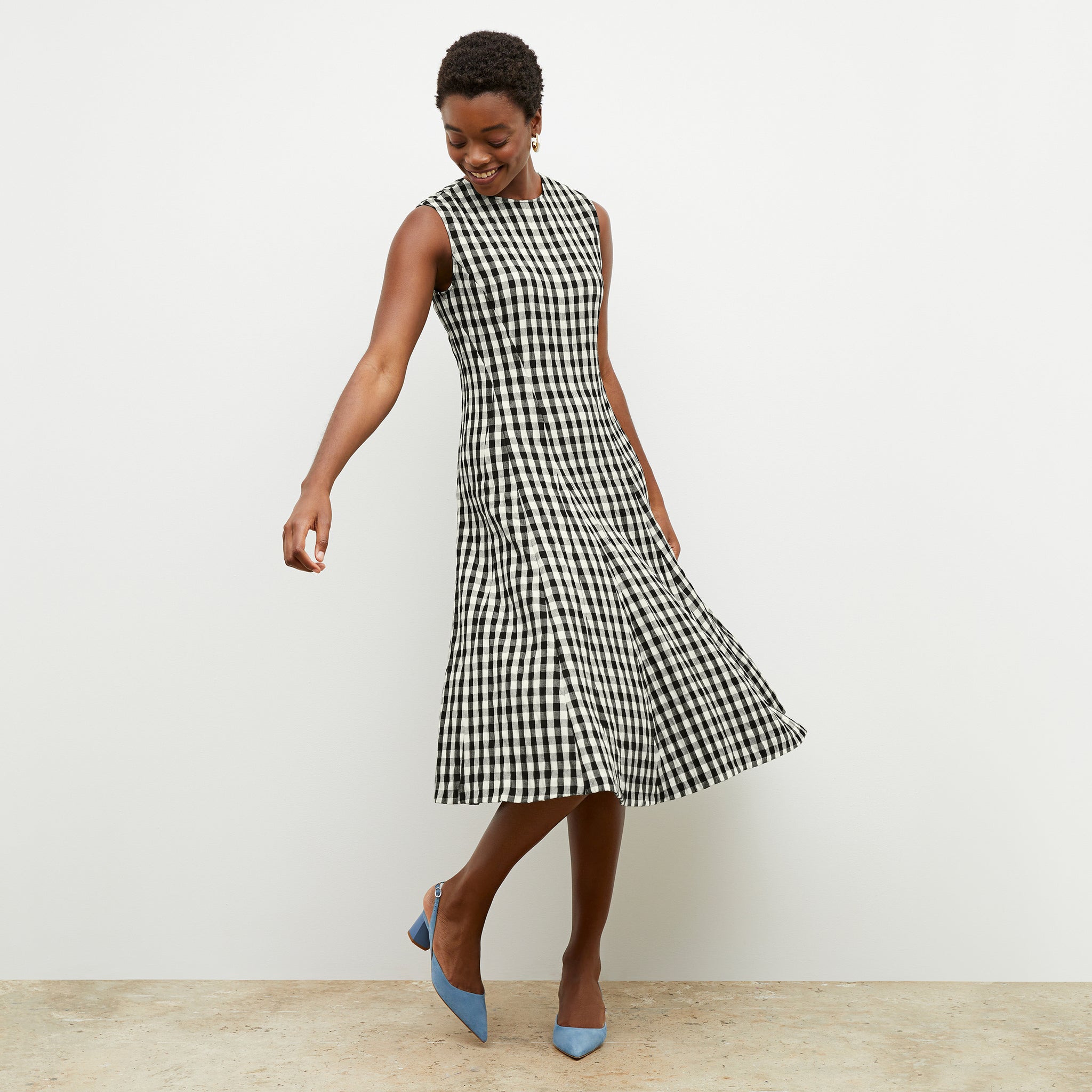 Front image of a woman wearing the nyla dress in black and white 