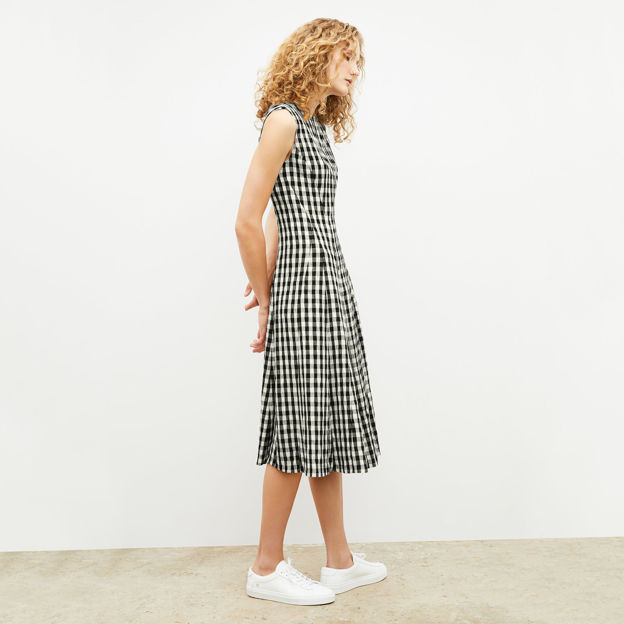Front image of a woman wearing the nyla dress in black and white