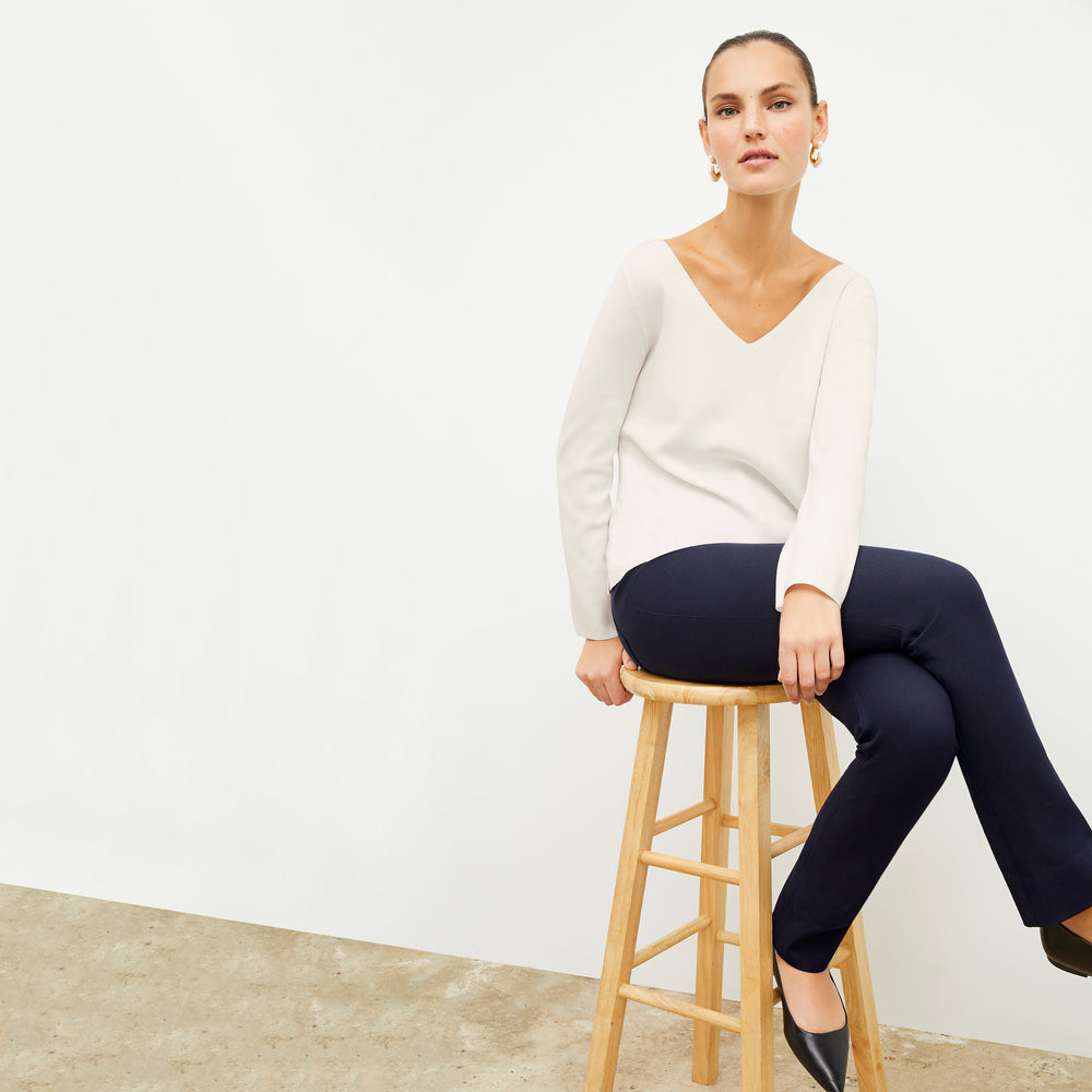 Front image of a woman wearing the kara top in ivory