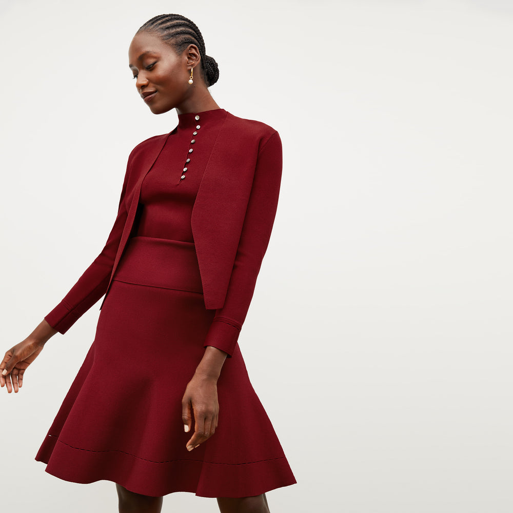 Front image of a woman wearing the luca skirt in maroon