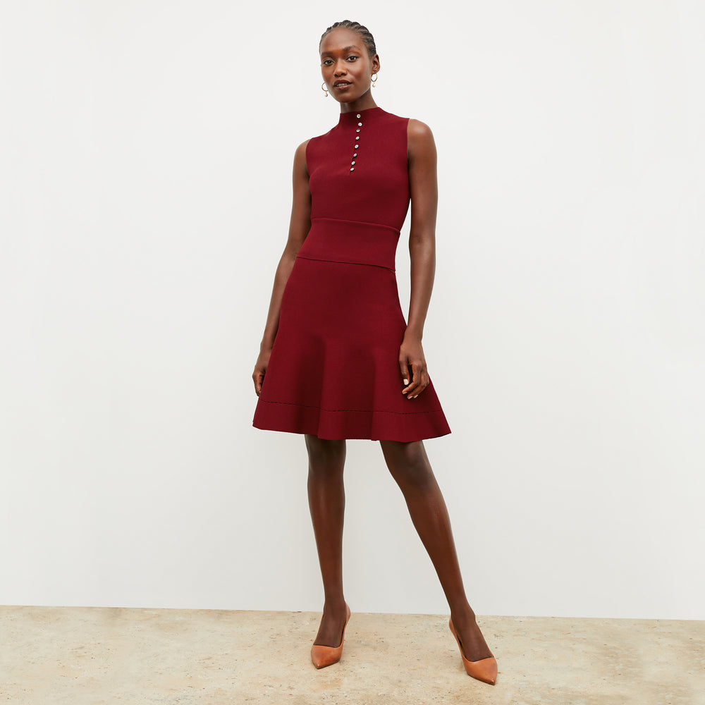 Front image of a woman wearing the luca skirt in maroon