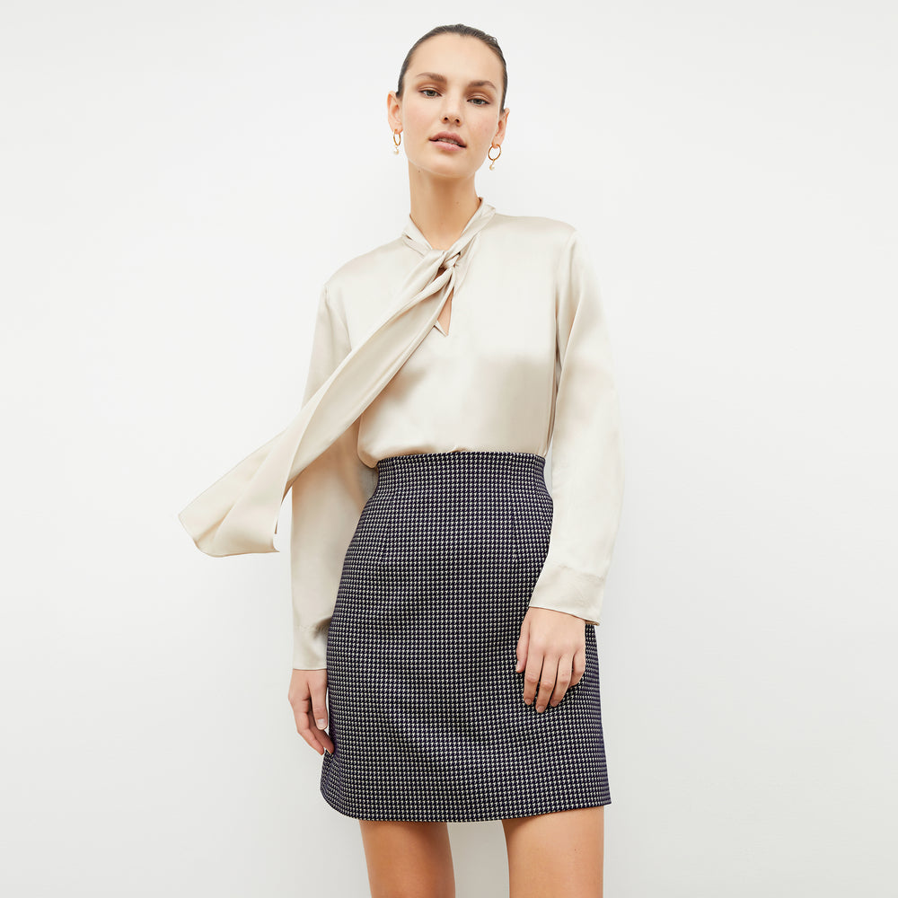 Front image of a woman wearing the whitney skirt in black and white