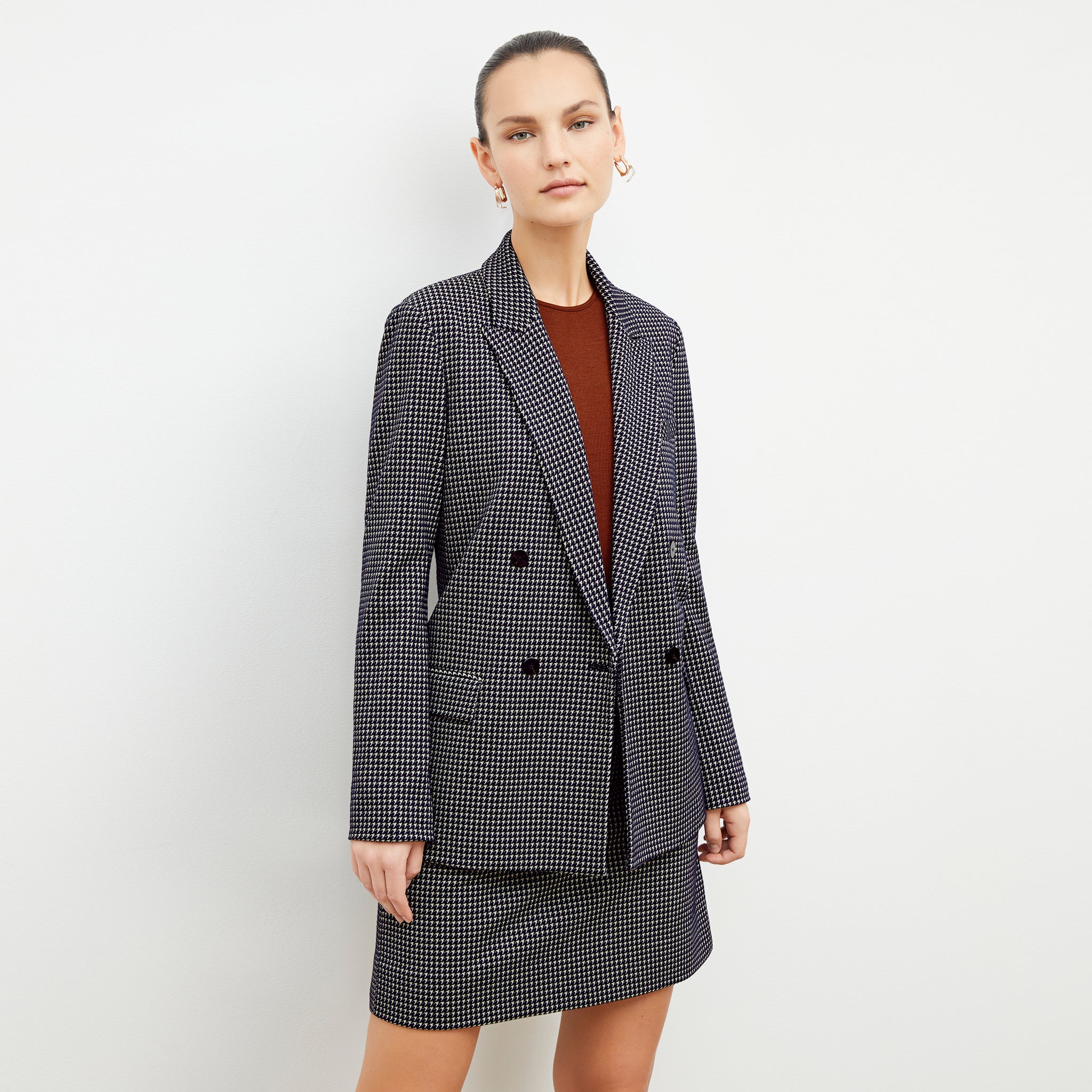 Front image of a woman wearing the ohara blazer in black and white 
