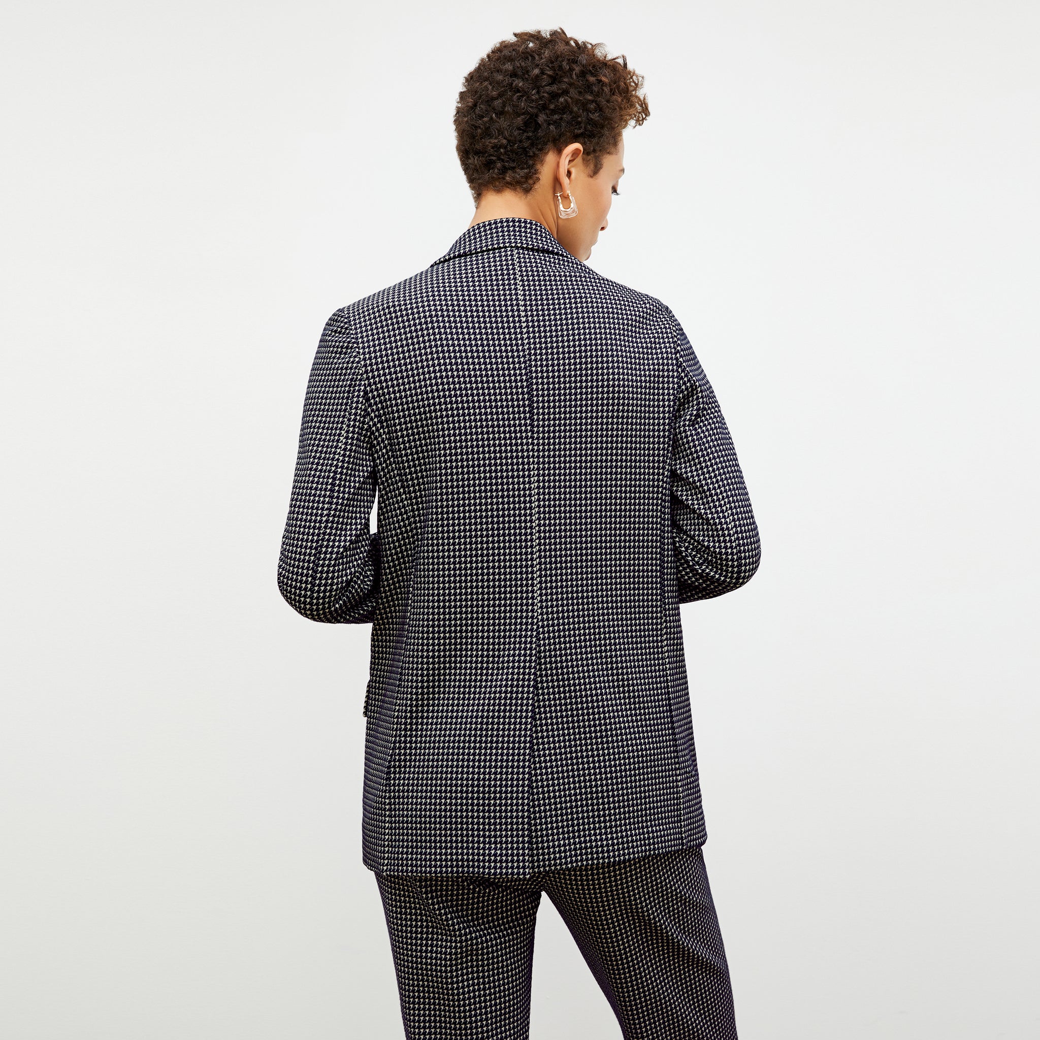 Back image of a woman wearing the ohara blazer in black and white