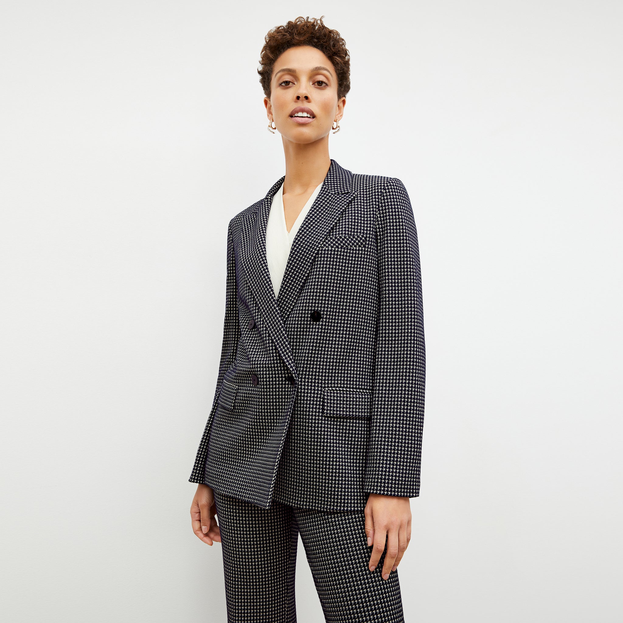 Front image of a woman wearing the ohara blazer in black and white
